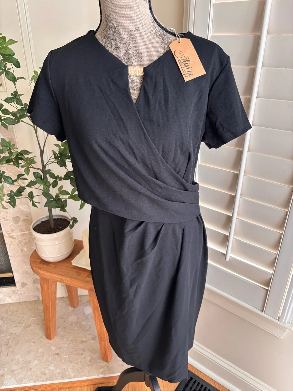 classic black short-sleeve faux-wrap midi dress featuring a draped surplice